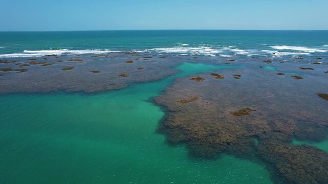 Natural pools in the sea off Taipu de Fora beach, a tourist spot on the Mara&uacute; Peninsula, coast of Bahia, Brazil, panoramic aerial view, coconut trees, blue and green sea, paradisiacal