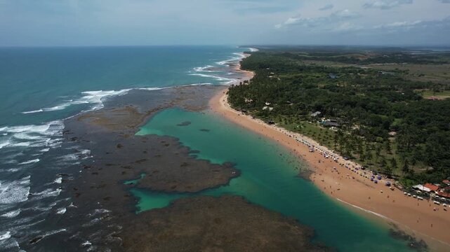 Natural pools in the sea off Taipu de Fora beach, a tourist spot on the Mara&uacute; Peninsula, coast of Bahia, Brazil, panoramic aerial view, coconut trees, blue and green sea, paradisiacal
