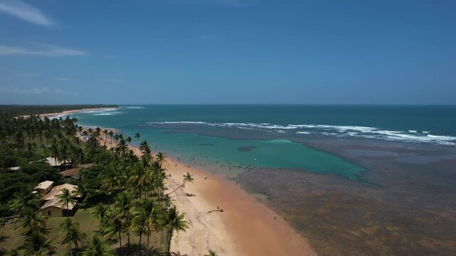 Natural pools in the sea off Taipu de Fora beach, a tourist spot on the Mara&uacute; Peninsula, coast of Bahia, Brazil, panoramic aerial view, coconut trees, blue and green sea, paradisiacal