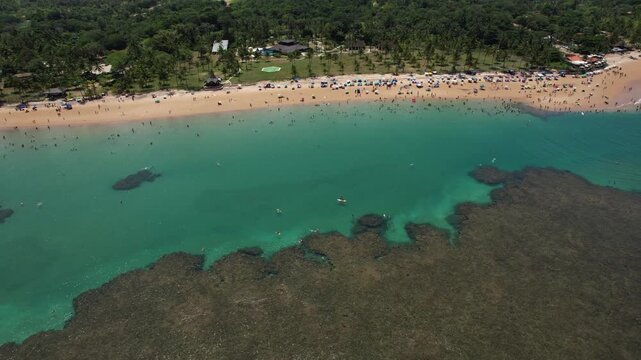 Natural pools in the sea off Taipu de Fora beach, a tourist spot on the Mara&uacute; Peninsula, coast of Bahia, Brazil, panoramic aerial view, coconut trees, blue and green sea, paradisiacal