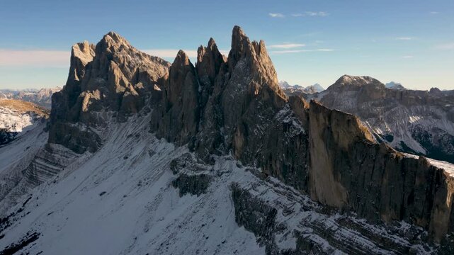Aerial backward reveal of jagged Seceda mountain ridgeline