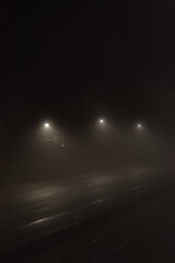 Street lights over foggy highway