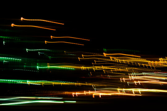 Abstract orange and green night city light trails. Urban traffic motion blur background texture. - Powered by Adobe