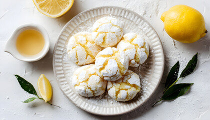 Top view of homemade lemon crinkle cookies on a plate with white background and copy space Flat lay