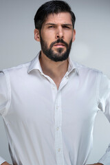 Obraz premium Half-length portrait of a man is standing confident wearing a white shirt in front of a plain white background in a working environment