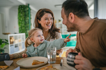 Young family enjoying breakfast together at home