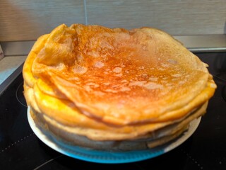 Folded Russian pancakes lie on a plate