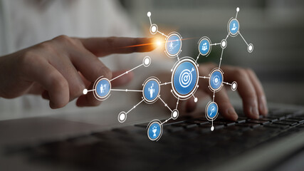 An innovative concept showcasing business strategy and planning through digital icons and target visualization on a laptop in a modern office environment. Tessel
