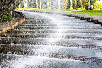 The photograph shows a very beautiful fountain in the city's summer park, which is located near the stairs along which water flows.