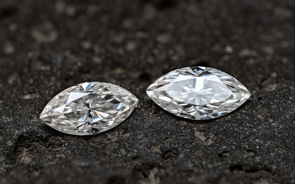 Two marquise cut diamonds on black background