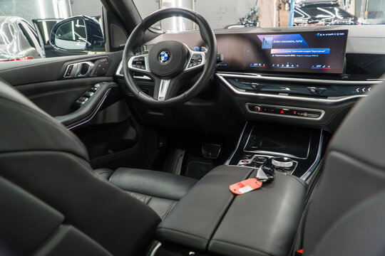 BMW X7 I (G07) M50d, Vehicle leather interior SUV car. Interior of modern car with dashboard, media system control panel, shift gear. German premium SUV car. BMW logo on the dashboard. 