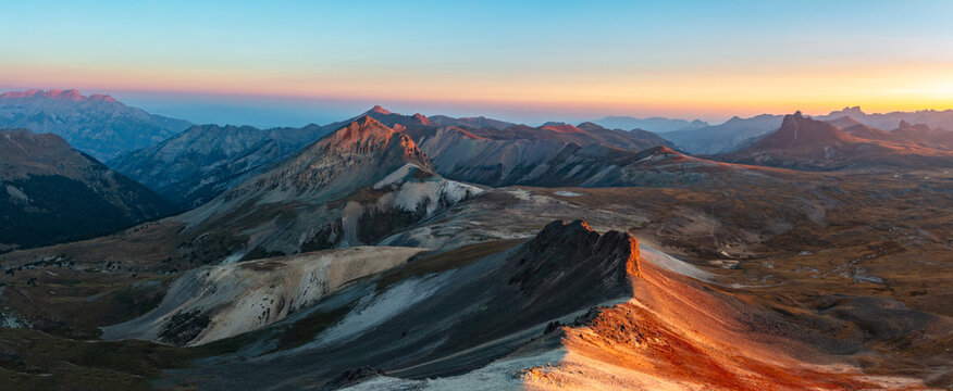 This stunning sunrise panorama features Colorado San Juan Range 13ers Unnamed 13140', Cow Benchmark, and Wildhorse Peak glowing underneath a vibrantly colored sky,