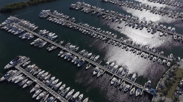 Aerial view of boat marina with son light reflecting on the water