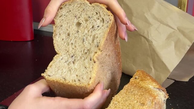 squeeze bread with hand structure Baker breaking hot and fresh bread. Male baker hands breaking homemade bread. Bakery concept. Craft organic bread. Close-up in 4K, UHD