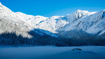Wonderful and huge snow covered cliffs surrounding the Lac-aux-Americains on a cold winter day, Gaspesie national park, QC, Canada