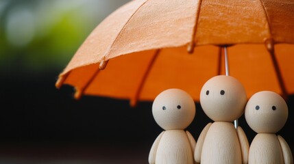 A charming scene of three small, brown wooden characters standing together underneath a vibrant orange-red paper parasol. The figures appear to be engaged in a whimsical moment