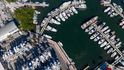 Aerial view of boat marina with son light reflecting on the water