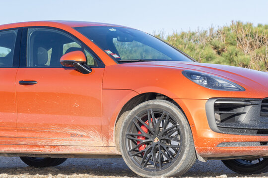 Orange porsche macan gts driving off road adventure