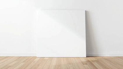 Blank square canvas leaning against a gray wall