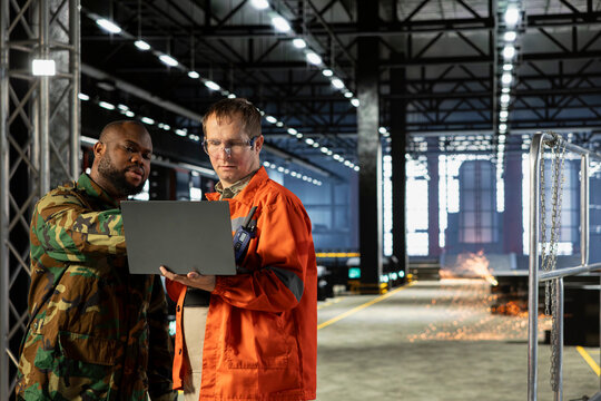Diverse military officer and staff managing production adapted for armament manufacturing, industrial mobilization supports the wartime economy through precision and national resilience. War effort.