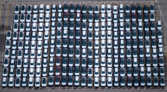 Aerial view of densely parked vehicles at port terminal.