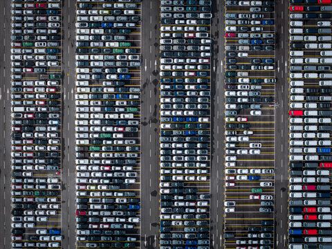 Aerial view of densely parked vehicles at port terminal.