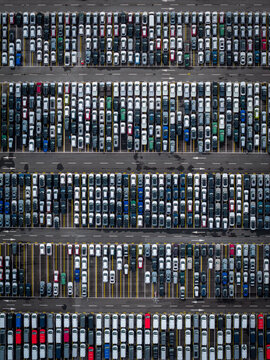 Aerial view of densely parked vehicles at port terminal.