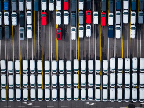 Aerial view of densely parked vehicles at port terminal.