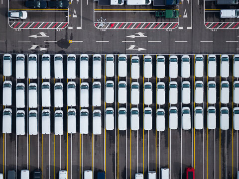 Aerial view of densely parked vehicles at port terminal.