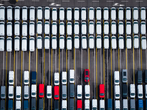 Aerial view of densely parked vehicles at port terminal.