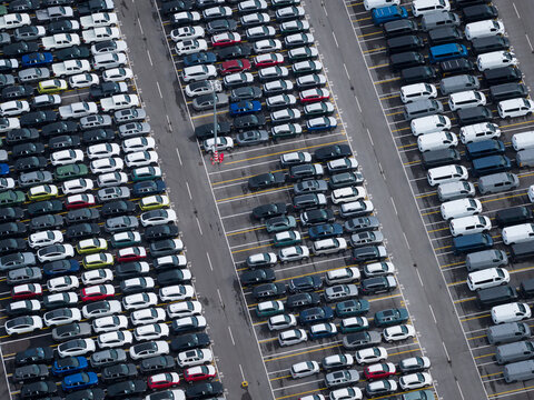 Aerial view of densely parked vehicles at port terminal.