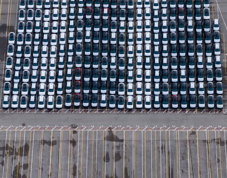 Aerial view of densely parked vehicles at port terminal.