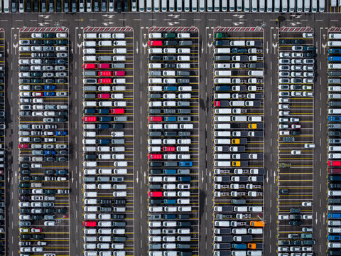 Aerial view of densely parked vehicles at port terminal.