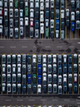 Aerial view of densely parked vehicles at port terminal.