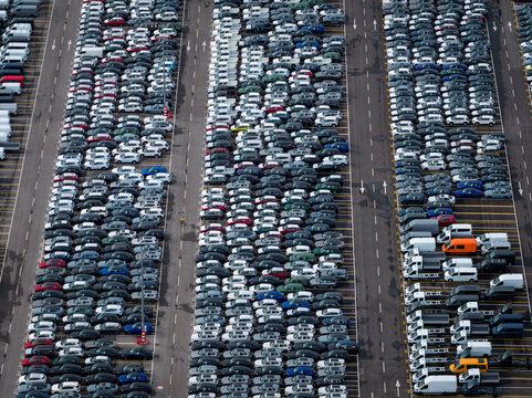 Aerial view of densely parked vehicles at port terminal.