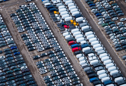 Aerial view of densely parked vehicles at port terminal.