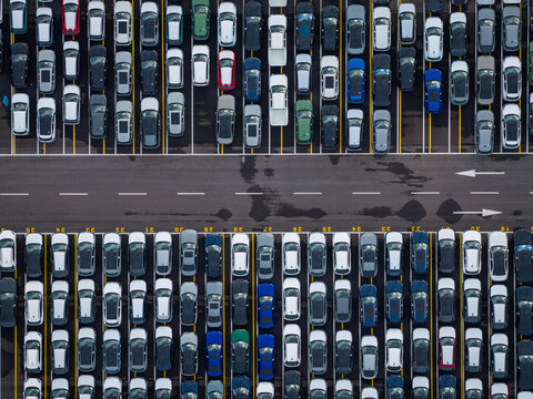 Aerial view of densely parked vehicles at port terminal.