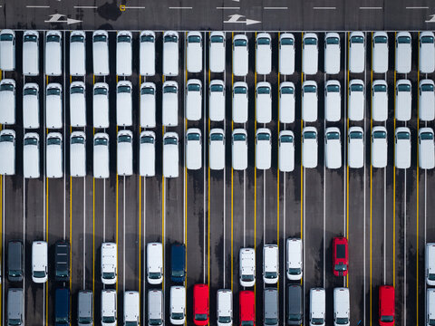 Aerial view of densely parked vehicles at port terminal.
