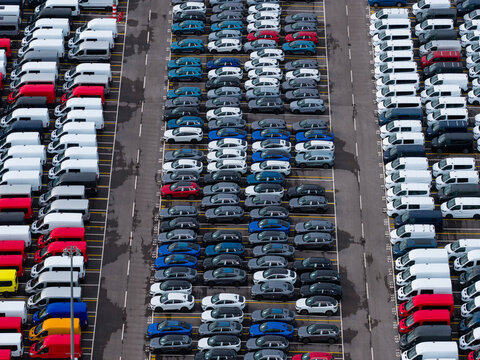 Aerial view of densely parked vehicles at port terminal.