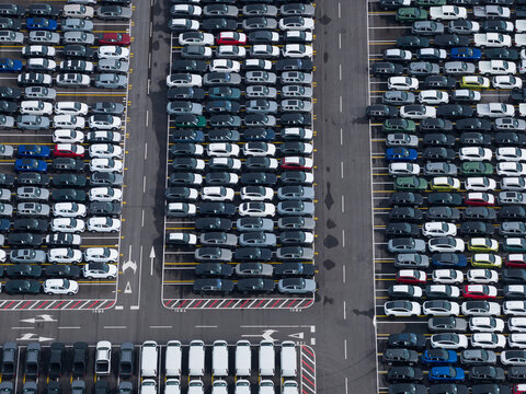 Aerial view of densely parked vehicles at port terminal.