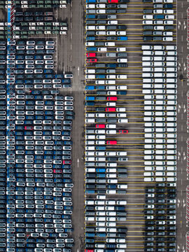 Aerial view of densely parked vehicles at port terminal.