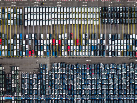 Aerial view of densely parked vehicles at port terminal.