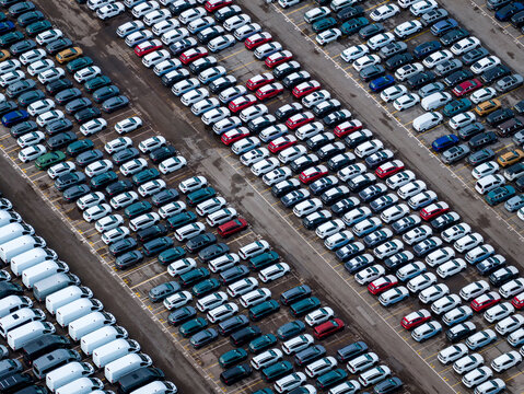 Aerial view of densely parked vehicles at port terminal.