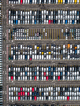 Aerial view of densely parked vehicles at port terminal.