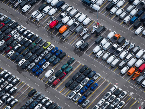 Aerial view of densely parked vehicles at port terminal.