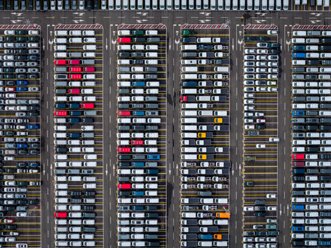 Aerial view of densely parked vehicles at port terminal.