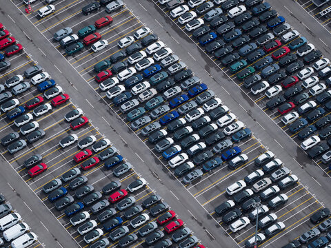 Aerial view of densely parked vehicles at port terminal.