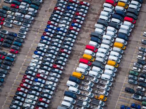 Aerial view of densely parked vehicles at port terminal.