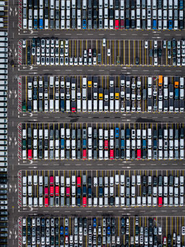 Aerial view of densely parked vehicles at port terminal.