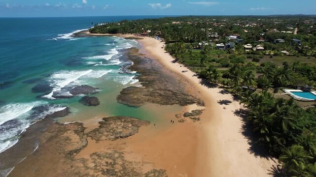 Panoramic aerial image of Tr&ecirc;s Coqueiros beach, southern coast of Bahia, Mara&uacute; Peninsula, Barra Grande, beach with coconut trees, large stretch of white sand, blue water, paradisiac